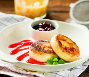 Enjoy a delicious breakfast with fluffy pancakes, fresh fruit, and creamy accompaniments.