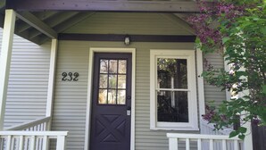 A house with a dark front door, a number '232' above it, and a small window to the right. - Fully Renovated Old Town Cottage Close to Downtown, City Park, and University  (Fort Collins)