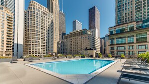 A rooftop pool with lounge chairs and a cityscape view. - LOCATION!!  2b/2b Condo, 51st Floor AMAZING Views, Pool and other Amenities! (Chicago)