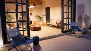 An open-plan living area with a sofa set, two rocking chairs, and a coffee table. - Stylish Sicilian Villa with private pool near the Beach. (ispica)