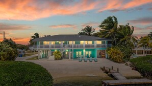 A two-story hotel with a balcony and a pool area. - Family Retreat Ocean front pool (Cudjoe Key)
