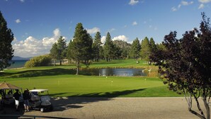 A golf course with a pond, trees, and a clear sky. - All The Comfort Of Home <br> Permit Number 0498 (South Lake Tahoe)