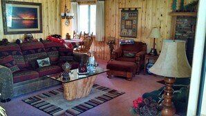 A cozy living room with a sofa set, a coffee table, a chair, and a lamp. - All The Comfort Of Home <br> Permit Number 0498 (South Lake Tahoe)