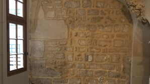 A room with a stone wall, a wooden door with glass panels, and a tiled floor. - Studio in Paris, Le Marais (Paris)