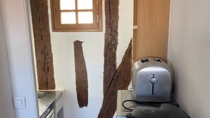 A compact kitchen with a window, a toaster, a kettle, and a dishwasher. - Studio in Paris, Le Marais (Paris)