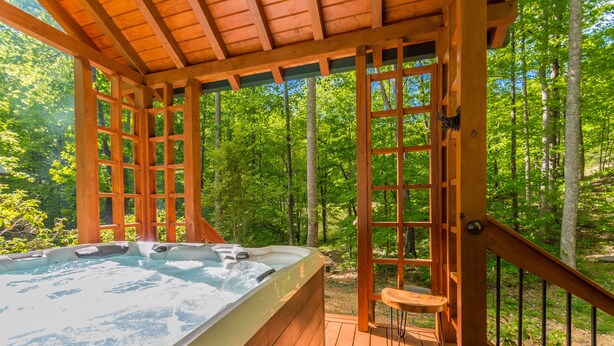 A hot tub under a wooden pergola with a view of a forest. - ♨️Hot Tub🛏️King Bed🔥Fireplace 🍷Wineries🌲Oasis🥾Hike🌎Comfy🔥Fire Pit⛲Pond 🆒 (Dahlonega)