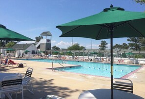 Relax by the pool surrounded by lounge chairs and umbrellas.