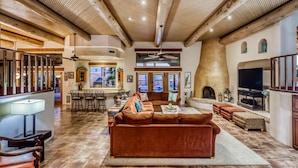 A spacious living area with a large brown sofa, a fireplace, and a television. - Labor Day Available! Over the top!! Luxury, spacious, quiet family retreat. (Lake Havasu City)