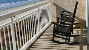 A balcony with a view of the ocean, white railing, and two black chairs. - Beautiful Oceanfront  Condo- Crescent Shores - Privately Owned and Maintained (North Myrtle Beach)