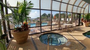 An indoor pool area with lounge chairs and a hot tub. - Brand New Reno! OF, End Unit, King bed, Quartz Counters, Shaker Cabinets (Myrtle Beach)