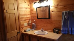 Combined shower/bathtub, towels, soap, toilet paper