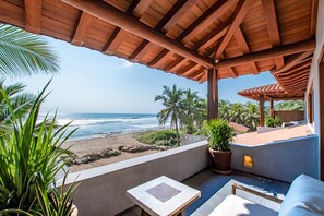 A covered outdoor area with a view of the ocean, a patio with a table and chairs, and potted plants. - Luxurious Troncones Beachfront! 30mins to Ixtapa (Troncones)