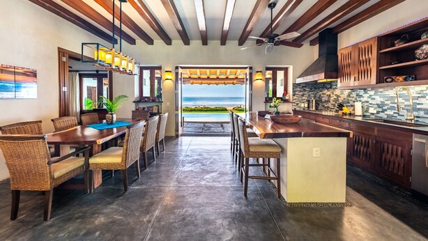 A spacious kitchen with a view of the beach, featuring wooden beams, a bar area, and a dining set. - Luxurious Troncones Beachfront! 30mins to Ixtapa (Troncones)