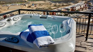 A hot tub with a towel and glasses, overlooking a beach and town. - 4966sf Penthouse Great Ocean Views +25% Off Golf (Los Cabos, Cabo San Lucas Centro)