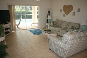 Living room with direct access to patio and pool