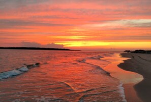 Enjoy the serene beach with gentle waves lapping at the shore.