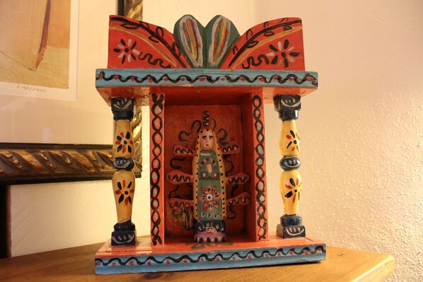 A wooden shrine with intricate carvings and a central figure.