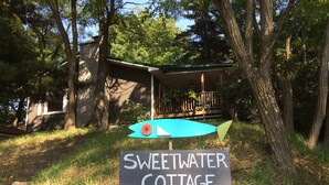 A sign for Sweetwater Cottage Rental with a contact number.
