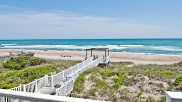Enjoy ocean views from the covered seating area overlooking the beach.