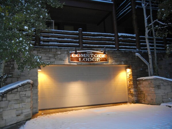 A snow-covered entrance to a lodge with a sign reading "COMSTOCK LODGE". - Cozy Ski Chalet,  Mountain Views and short walk to base of Deer Valley! (Park City)