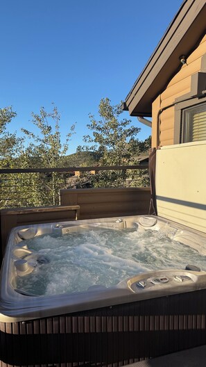 A hot tub with a view of a house and trees. - Cozy Ski Chalet,  Mountain Views and short walk to base of Deer Valley! (Park City)