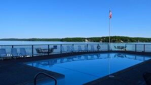 A swimming pool with a view of a lake and a flag. -  Remodeled Ledges Lakefront 2BR Condo! No Steps. Walk-In Unit w/ WiFi. (Osage Beach)