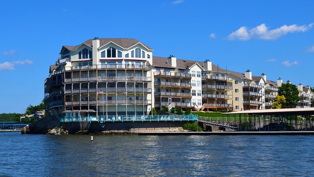 A waterfront hotel with multiple balconies, a covered walkway, and a view of the water. -  Remodeled Ledges Lakefront 2BR Condo! No Steps. Walk-In Unit w/ WiFi. (Osage Beach)