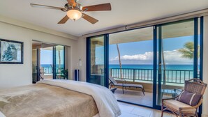 A bedroom with a bed, a ceiling fan, and a balcony with a view of the ocean. - NOTHING BUT OCEAN VIEWS! Remodeled, AC, direct ocean front, large 2bd/2bth (Lahaina)