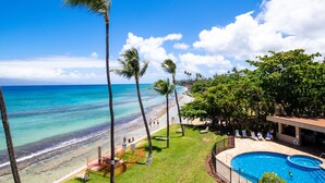A beachfront property with a swimming pool, palm trees, and a view of the ocean. - NOTHING BUT OCEAN VIEWS! Remodeled, AC, direct ocean front, large 2bd/2bth (Lahaina)