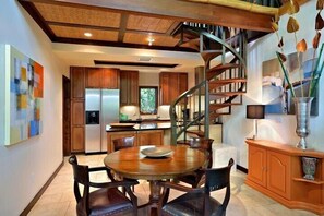 Enjoy cooking in this well-equipped kitchen with a central island, stainless steel appliances, and a large window offering a view of the outdoors.