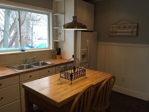 Enjoy cooking with a view of the outdoors from this kitchen, featuring a sink and window.