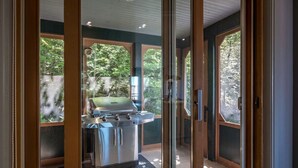A modern kitchen with a stainless steel range hood and a green countertop. - Tremblant Prestige - Clairiere 404 (Mont-Tremblant)