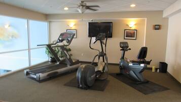 A gym with treadmills, an elliptical, and a stationary bike.