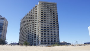 A high-rise hotel with a modern design, featuring multiple balconies and a uniform facade. - Oceanfront Penthouse, great views, Best Amenities, Spacious Sleeps 14, 3 Pools (Ocean City)