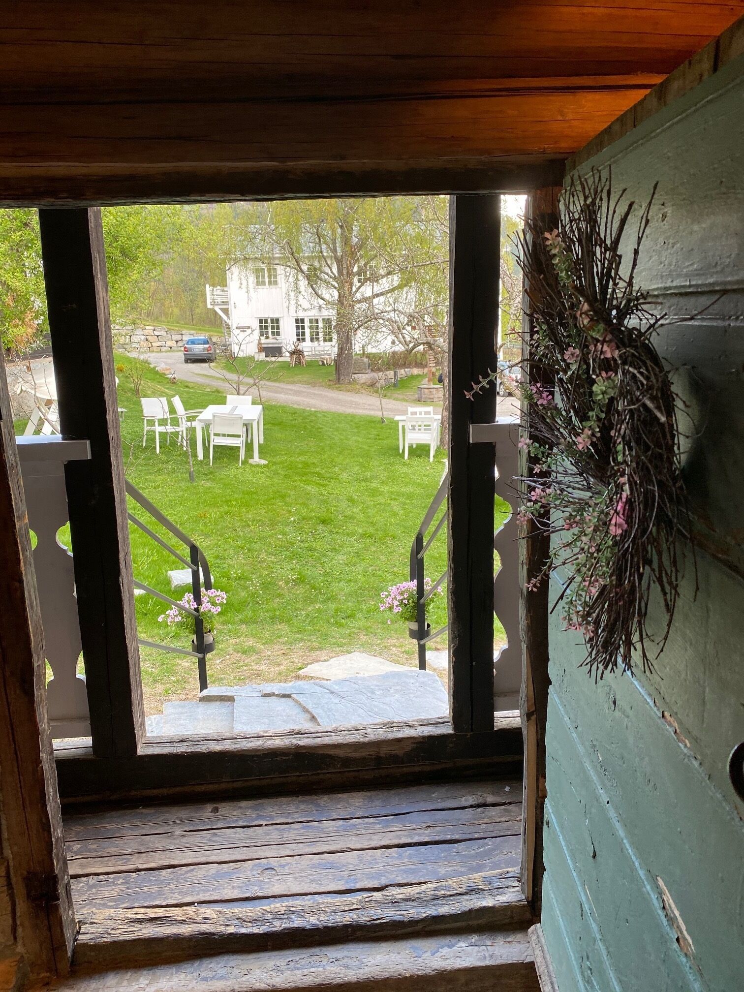 A view from a window with a wooden staircase leading outside.