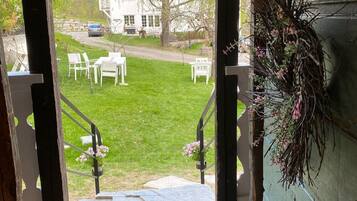 A view from a window with a wooden staircase leading outside.