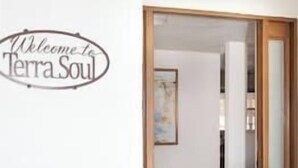 A welcome sign reading "Welcome to TerraSoul" above a doorway leading into a room with a tiled floor and a framed picture on the wall.