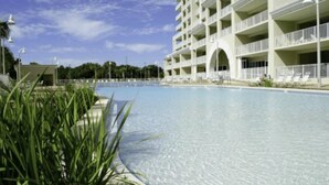 A large swimming pool with a multi-story building in the background. - Ariel Dunes #2107 2BR/2BA - Gorgeous Gulf Views (Miramar Beach)