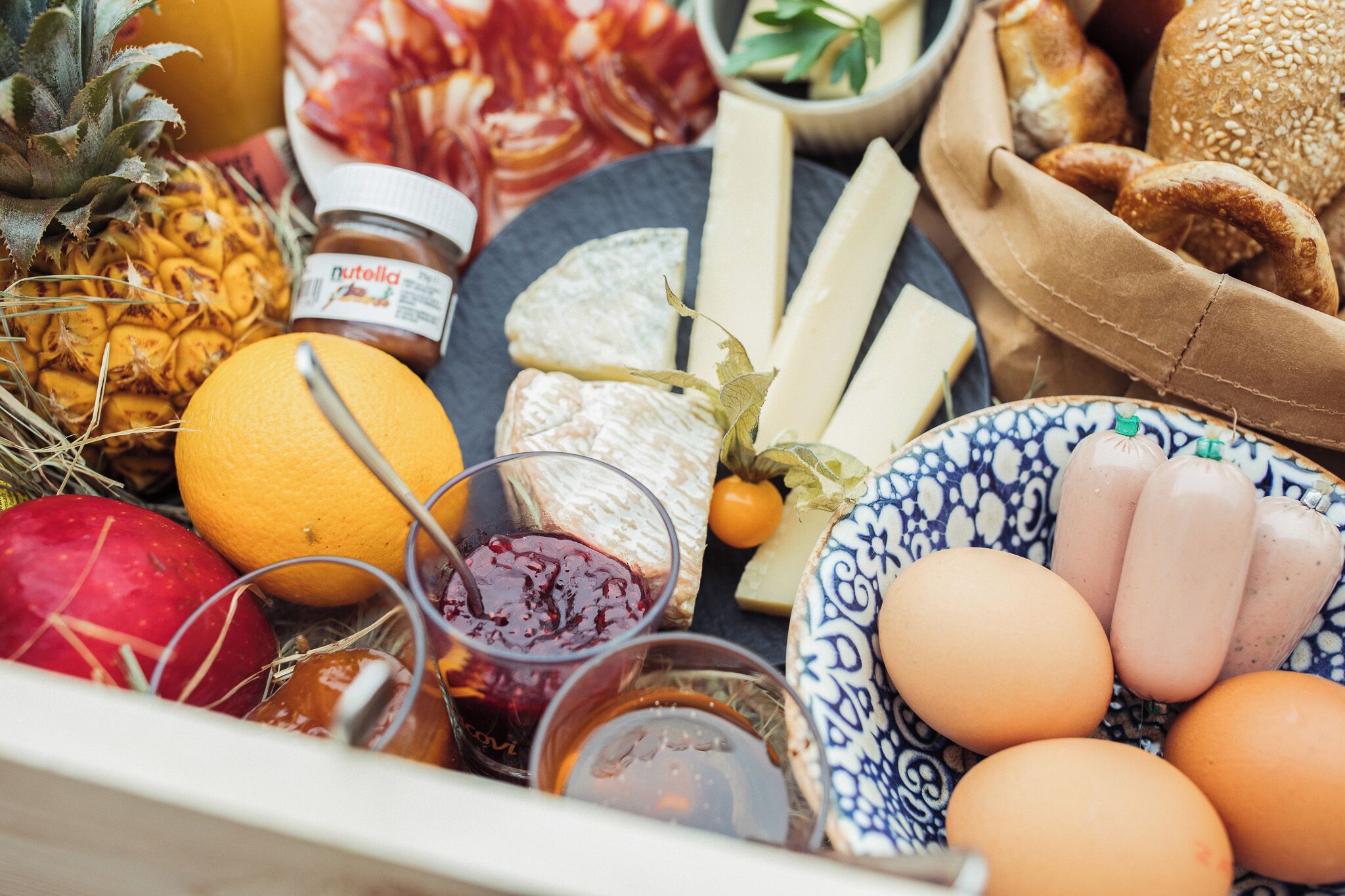 A variety of food items including fruits, cheese, bread, and eggs.
