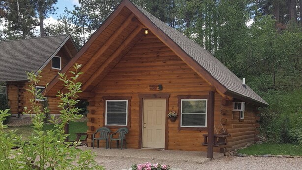 A log cabin with a pitched roof, a front door, and two windows. - Sunset Ridge #2 at Rustic Ridge (Keystone)