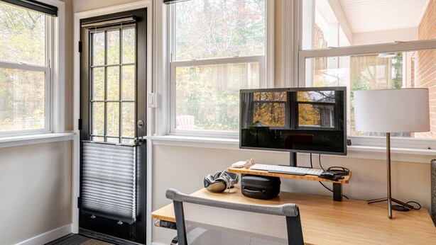 A room with a desk, a computer monitor, a lamp, and a radiator. - Remodeled, Updated, Perfect Location Next to Downtown/PSU! (State College)