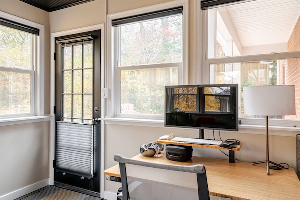 Sunroom has lots of light, electric shades, standing desk, & entry to back patio
