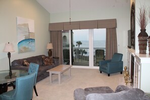 Relax in this inviting living room with a sofa, loveseat, and chair, perfect for unwinding with a view of the outdoors.