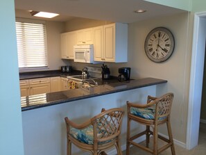 Enjoy cooking in this well-equipped kitchen with a central island and bar-style seating.