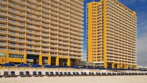 A high-rise hotel with multiple balconies and a beachside location. - Splash resort - Beachfront - Family-friendly - Optional beach services and more! (Panama City Beach)