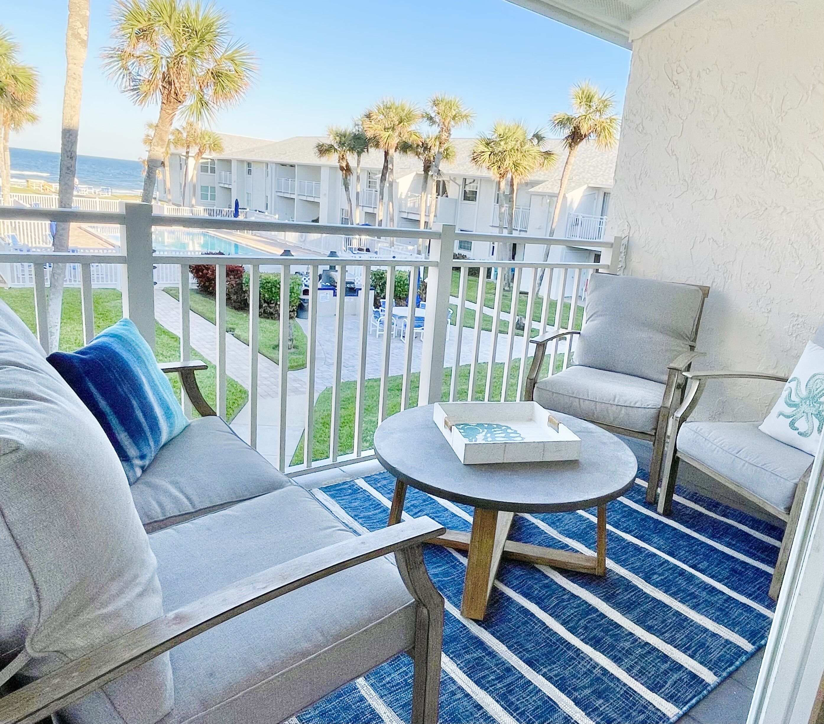 Perfect views of the ocean, pool, courtyard from this remodeled coastal condo   