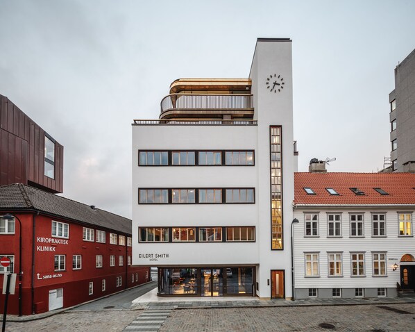 A modern hotel with a clock tower, multiple floors, and a visible entrance. - Eilert Smith Hotel (Stavanger)