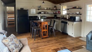 Een gezellige keuken met houten kastjes, een eettafel en een inbouwoven.
