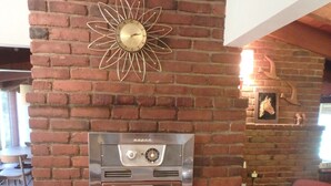 A brick wall with a built-in stainless steel oven and a decorative sun-like metal piece above it. - Authentic Mid-Century Marvel, in the quiet and desirable Mid Town neighborhood. (Bend)