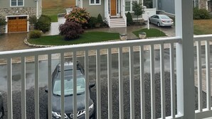 A residential area with houses, a driveway, and a car. - Gorgeous Designer Contemporary Beach House with Views (Clinton)